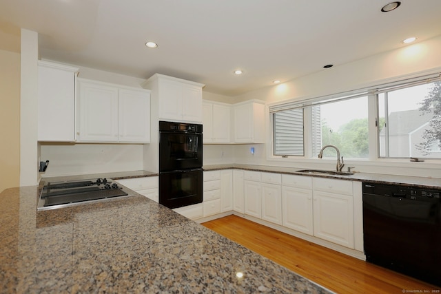 73 Harbour View Pl Unit 73, Stratford, CT 06615 - kitchen with black appliances, light wood-style flooring, light stone countertops, white cabinets, and recessed lighting