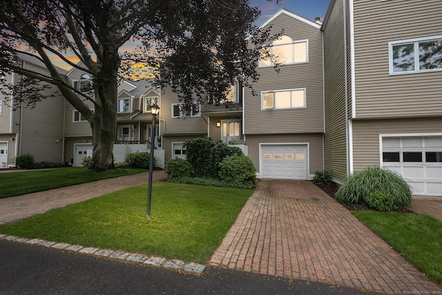 73 Harbour View Pl Unit 73, Stratford, CT 06615 - view of front facade featuring a garage, a lawn, and driveway