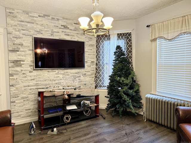 14 Natalie St, Hartford, CT 06106 - living area featuring radiator heating unit, a chandelier, a textured ceiling, and wood finished floors
