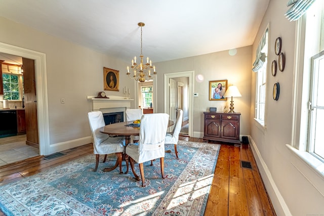 55 Main St, East Haddam, CT 06423 - dining room featuring a chandelier, light wood-type flooring, and a fireplace