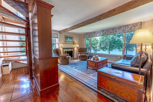 55 Main St, East Haddam, CT 06423 - living area featuring hardwood / wood-style flooring, beamed ceiling, and a glass covered fireplace