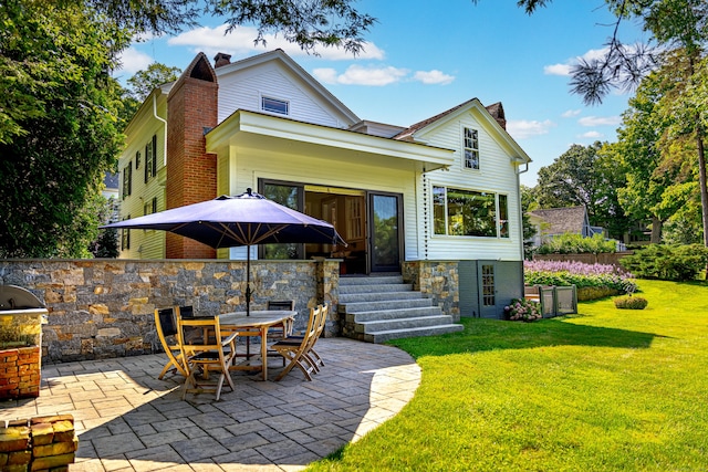 55 Main St, East Haddam, CT 06423 - back of house featuring a patio, a chimney, a lawn, and entry steps