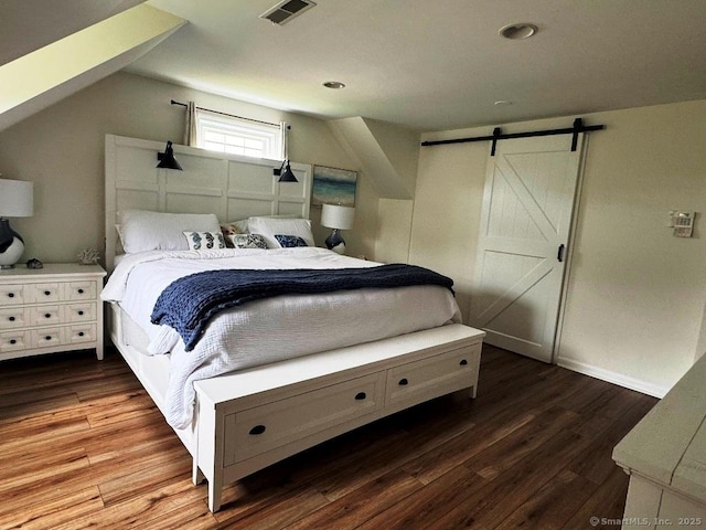 8 Breezy Knoll Ave, Wolcott, CT 06716 - bedroom with wood finished floors, lofted ceiling, and a barn door