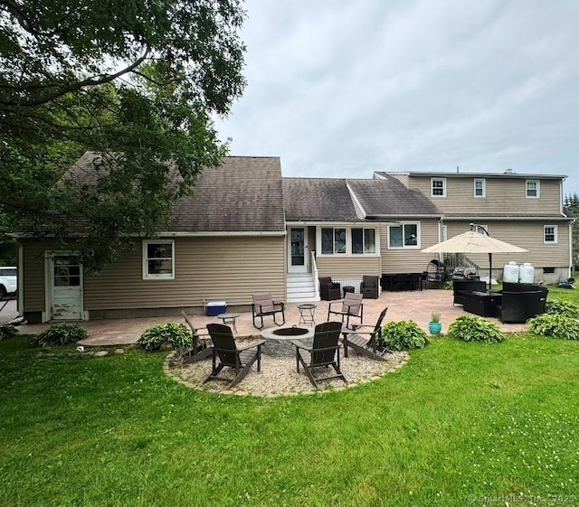 8 Breezy Knoll Ave, Wolcott, CT 06716 - rear view of property featuring a patio area, a lawn, and a fire pit