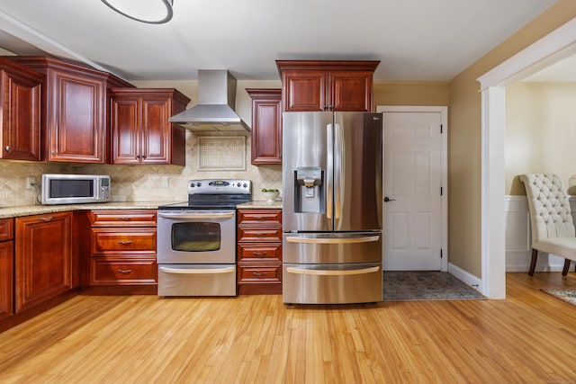 5 Goldfinch Ter, East Lyme, CT 06333 - kitchen featuring appliances with stainless steel finishes, wall chimney exhaust hood, reddish brown cabinets, and light wood finished floors