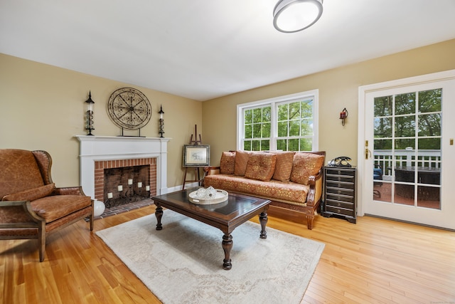 5 Goldfinch Ter, East Lyme, CT 06333 - living room featuring light wood-style floors and a brick fireplace