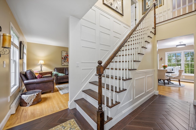 5 Goldfinch Ter, East Lyme, CT 06333 - stairway with a baseboard radiator, parquet flooring, and wainscoting