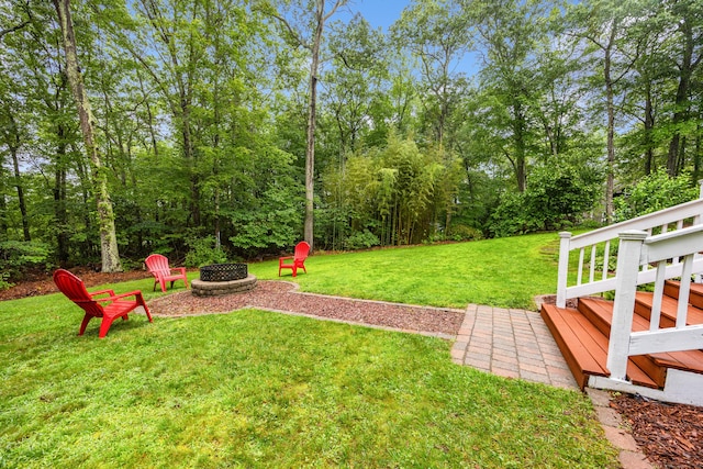 5 Goldfinch Ter, East Lyme, CT 06333 - view of grassy yard with a fire pit and a wooden deck