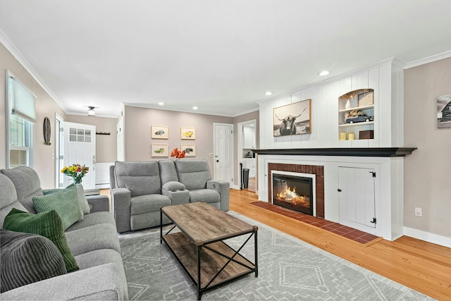 1027 Monroe Tpke, Monroe, CT 06468 - living area with wood finished floors, ornamental molding, a fireplace with flush hearth, and recessed lighting