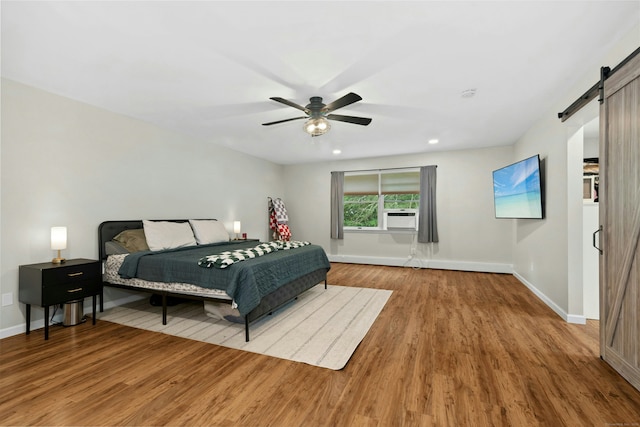 1027 Monroe Tpke, Monroe, CT 06468 - bedroom featuring a barn door, wood finished floors, a ceiling fan, cooling unit, and recessed lighting