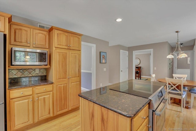97 Cherry Swamp Rd, East Haddam, CT 06469 - kitchen featuring appliances with stainless steel finishes, light wood-style floors, a center island, dark stone counters, and recessed lighting