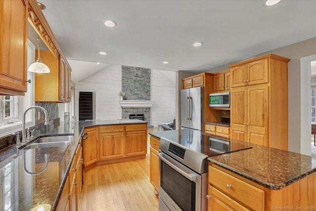 97 Cherry Swamp Rd, East Haddam, CT 06469 - kitchen featuring appliances with stainless steel finishes, light wood-style flooring, a stone fireplace, backsplash, and vaulted ceiling