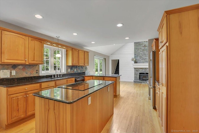 97 Cherry Swamp Rd, East Haddam, CT 06469 - kitchen with a peninsula, black electric stovetop, lofted ceiling, light wood-style floors, and a fireplace