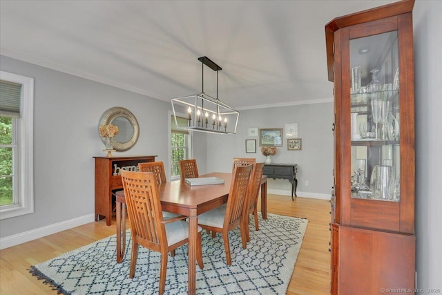 97 Cherry Swamp Rd, East Haddam, CT 06469 - dining room featuring healthy amount of natural light, a chandelier, light wood-type flooring, and crown molding