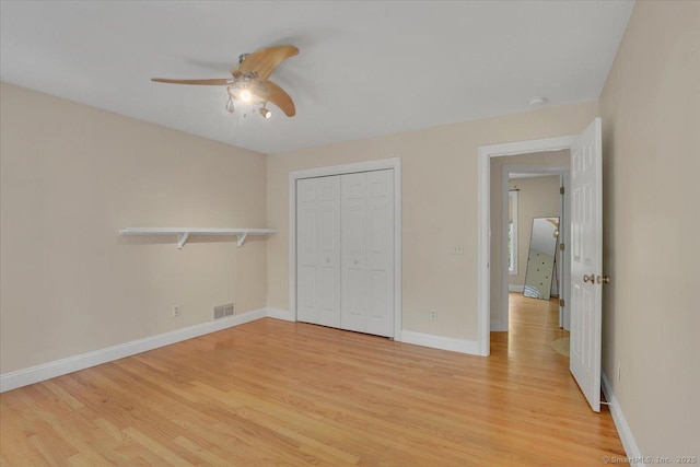 97 Cherry Swamp Rd, East Haddam, CT 06469 - unfurnished bedroom with light wood-style floors, a closet, and a ceiling fan