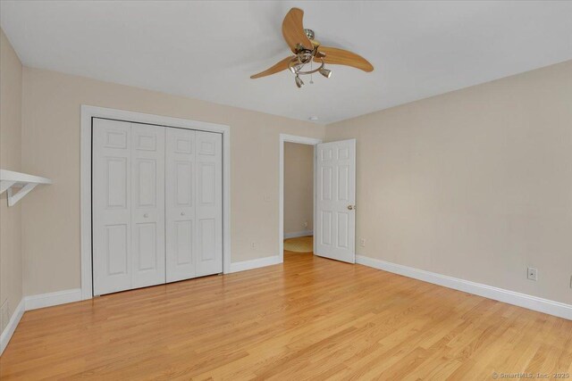 97 Cherry Swamp Rd, East Haddam, CT 06469 - unfurnished bedroom with light wood-type flooring, a closet, and a ceiling fan