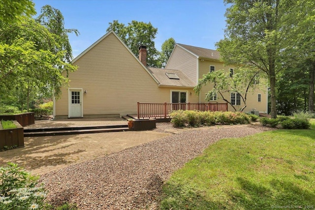 97 Cherry Swamp Rd, East Haddam, CT 06469 - rear view of property featuring a wooden deck, a chimney, and a lawn