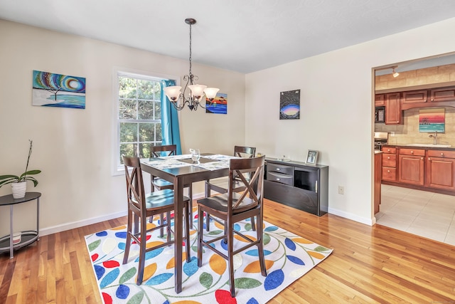 663 W Ave Unit A24, Milford, CT 06461 - dining area with a chandelier and light wood-style flooring
