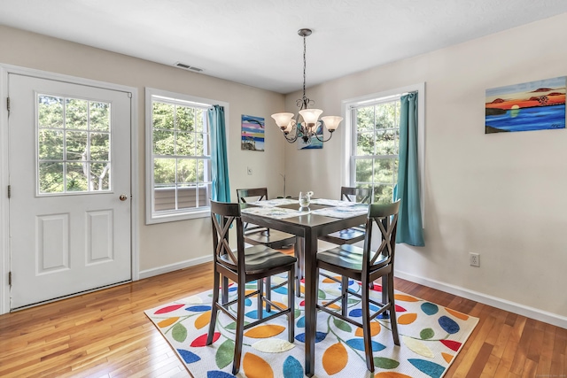 663 W Ave Unit A24, Milford, CT 06461 - dining space with hardwood / wood-style flooring and a chandelier