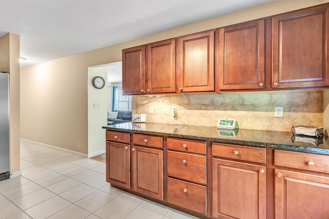 663 W Ave Unit A24, Milford, CT 06461 - kitchen with dark stone countertops, backsplash, and brown cabinets