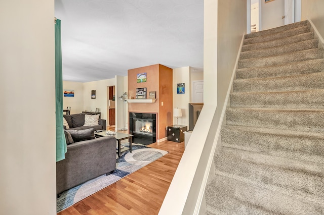663 W Ave Unit A24, Milford, CT 06461 - staircase with wood finished floors and a fireplace with flush hearth