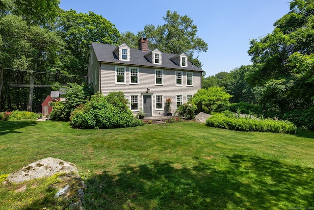 56 Turtleback Rd, Wilton, CT 06897 - back of house with a lawn and a chimney