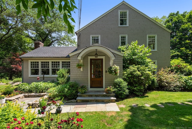 56 Turtleback Rd, Wilton, CT 06897 - view of front facade featuring a front yard, a chimney, and a shingled roof