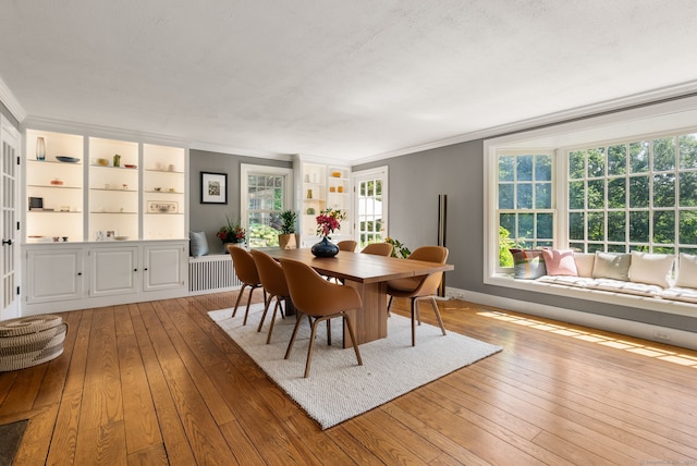 56 Turtleback Rd, Wilton, CT 06897 - dining room featuring hardwood / wood-style flooring, ornamental molding, radiator heating unit, and built in shelves