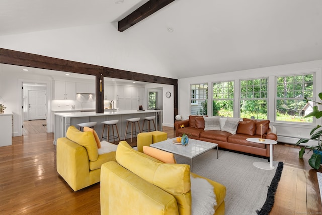 56 Turtleback Rd, Wilton, CT 06897 - living room with hardwood / wood-style floors, high vaulted ceiling, beam ceiling, a baseboard heating unit, and healthy amount of natural light