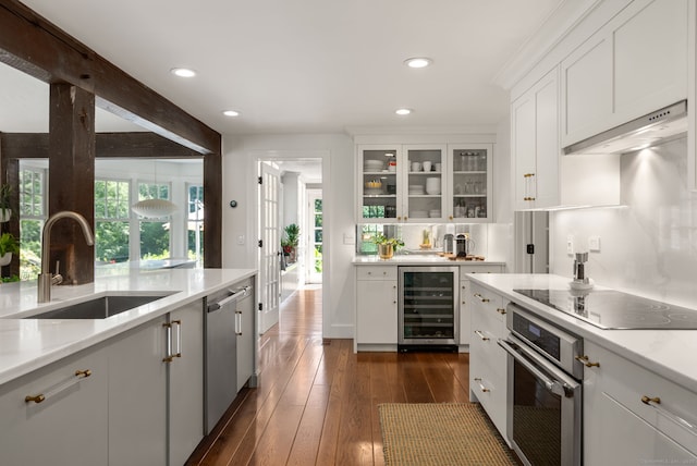 56 Turtleback Rd, Wilton, CT 06897 - kitchen featuring beverage cooler, stainless steel appliances, white cabinets, glass insert cabinets, and recessed lighting