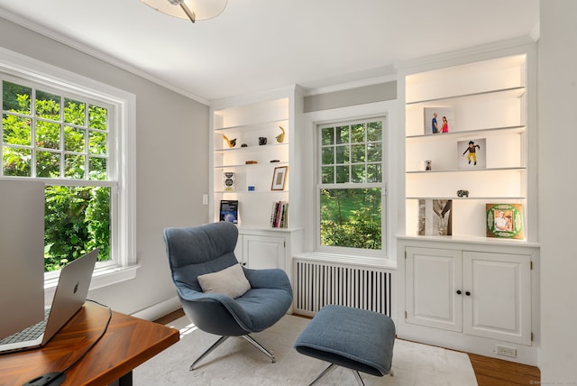 56 Turtleback Rd, Wilton, CT 06897 - living area featuring radiator heating unit, ornamental molding, built in features, and wood finished floors