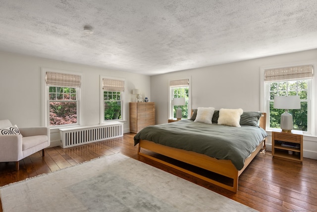 56 Turtleback Rd, Wilton, CT 06897 - bedroom with radiator, wood-type flooring, and a textured ceiling