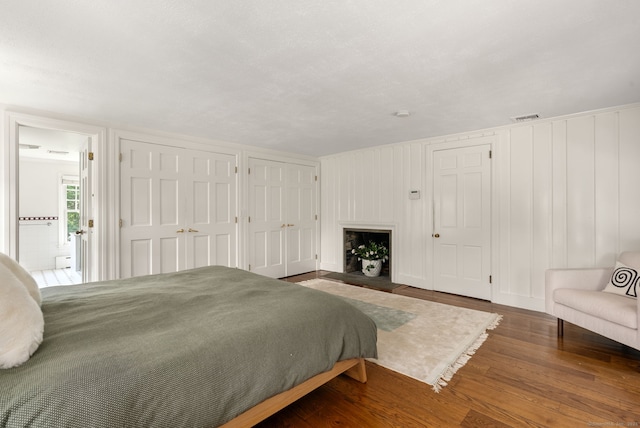 56 Turtleback Rd, Wilton, CT 06897 - bedroom featuring multiple closets, wood finished floors, and a decorative wall