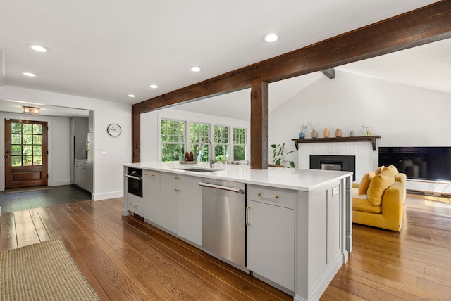 56 Turtleback Rd, Wilton, CT 06897 - kitchen featuring dishwasher, open floor plan, light countertops, dark wood-style floors, and recessed lighting