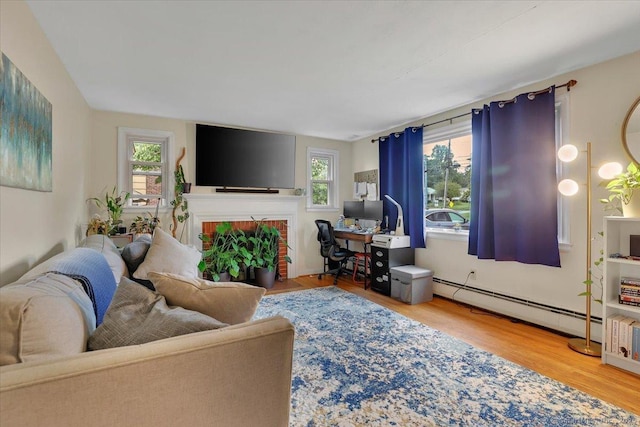 118 W Hartford Rd, Newington, CT 06111 - living room featuring a baseboard radiator, wood finished floors, an office area, and a fireplace