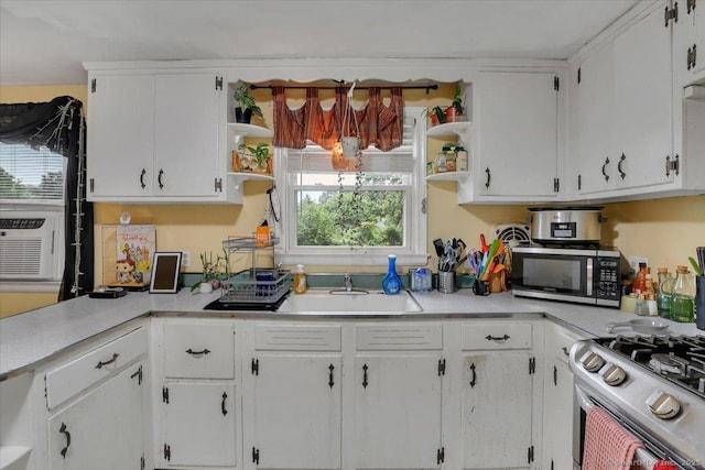 118 W Hartford Rd, Newington, CT 06111 - kitchen featuring open shelves, appliances with stainless steel finishes, and white cabinetry
