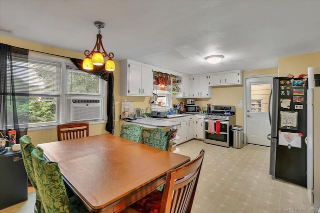 118 W Hartford Rd, Newington, CT 06111 - kitchen with appliances with stainless steel finishes, white cabinetry, light countertops, and hanging light fixtures