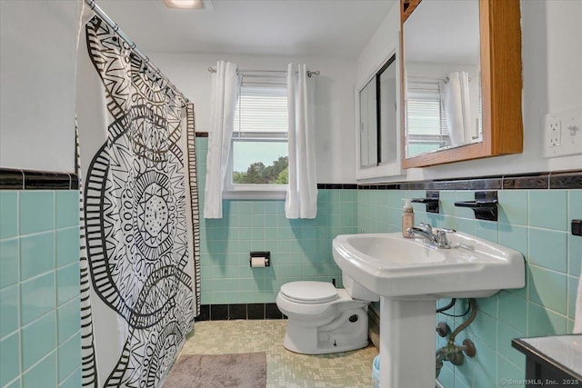 118 W Hartford Rd, Newington, CT 06111 - full bathroom featuring tile walls, a wainscoted wall, tile patterned flooring, and a shower with curtain