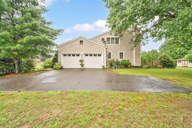 17 Landing Cir, Windsor, CT 06095 - mid-century inspired home with asphalt driveway, a front lawn, and an attached garage