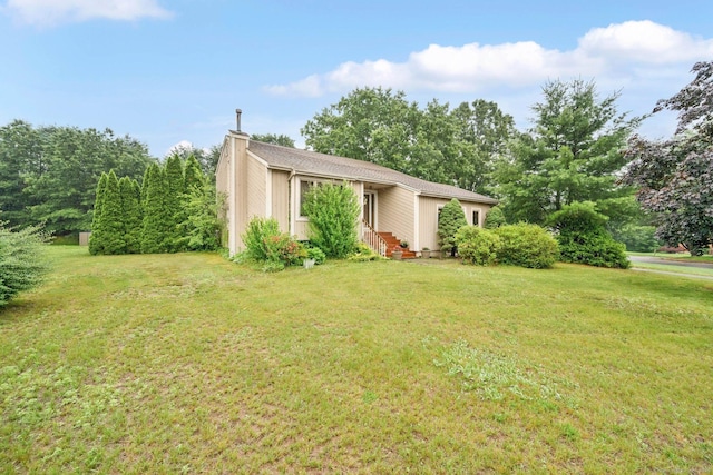 17 Landing Cir, Windsor, CT 06095 - view of front facade featuring a chimney and a front lawn