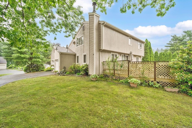17 Landing Cir, Windsor, CT 06095 - view of side of property with a lawn, a chimney, a garage, and asphalt driveway