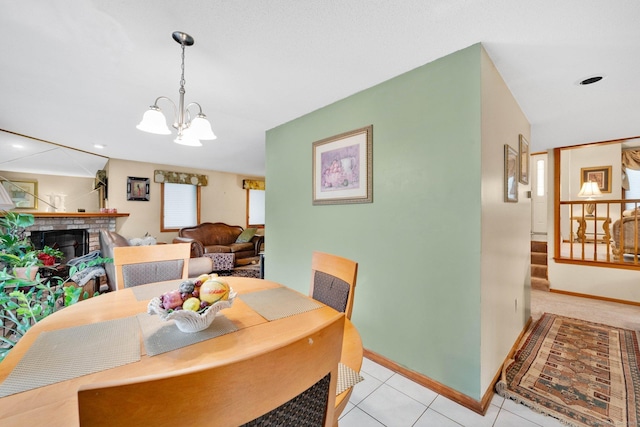 17 Landing Cir, Windsor, CT 06095 - dining area featuring a chandelier, a brick fireplace, light tile patterned flooring, and stairway