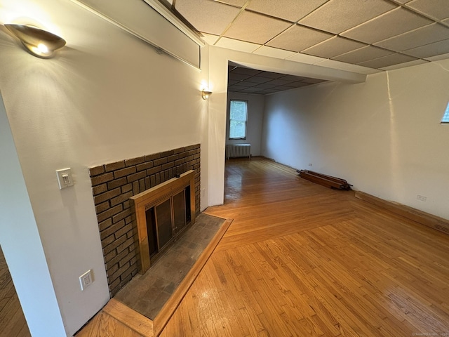 91 Hyde St, New Haven, CT 06512 - unfurnished living room with radiator heating unit, hardwood / wood-style floors, and a fireplace