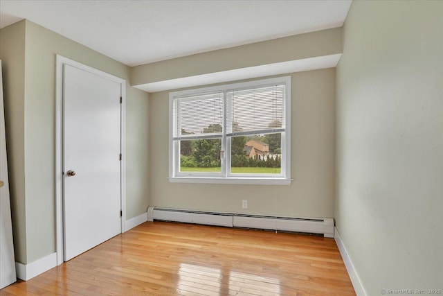 401 Berlin St, Southington, CT 06489 - unfurnished bedroom with a baseboard heating unit and light wood-style floors