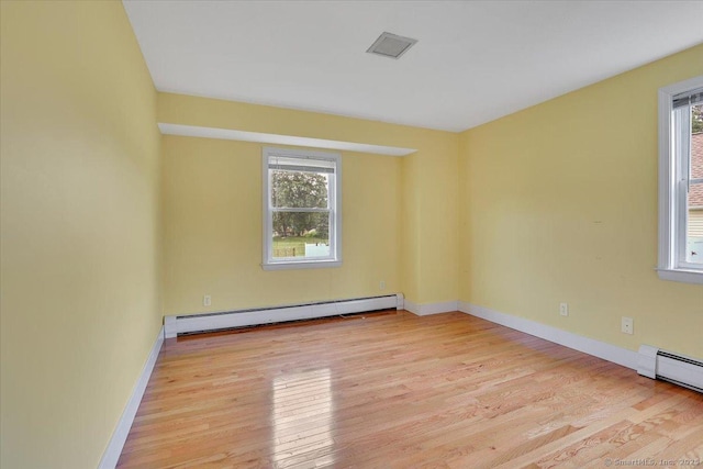 401 Berlin St, Southington, CT 06489 - empty room with baseboard heating, plenty of natural light, and wood finished floors