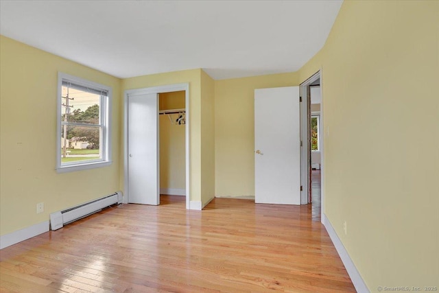401 Berlin St, Southington, CT 06489 - unfurnished bedroom with baseboard heating, light wood-style floors, and a closet