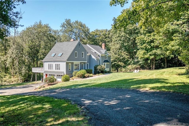 26 Ruscoe Rd, Wilton, CT 06897 - view of front facade featuring driveway, a garage, a front yard, and a chimney