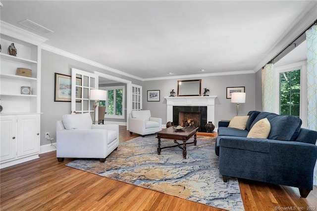 26 Ruscoe Rd, Wilton, CT 06897 - living room featuring plenty of natural light, wood finished floors, ornamental molding, and a fireplace
