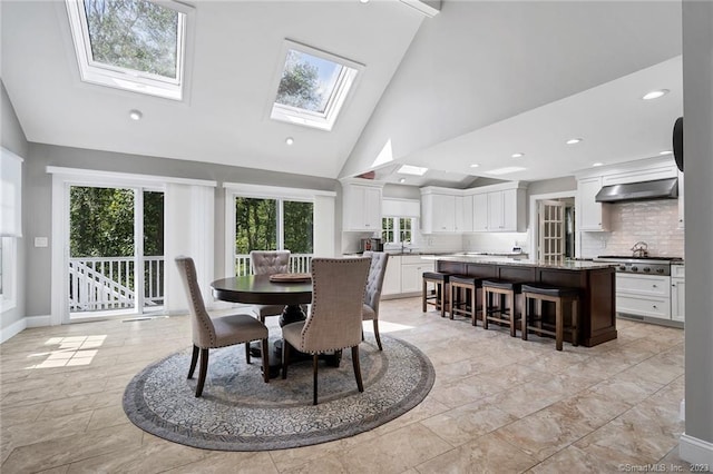 26 Ruscoe Rd, Wilton, CT 06897 - dining space with a skylight, healthy amount of natural light, high vaulted ceiling, and recessed lighting