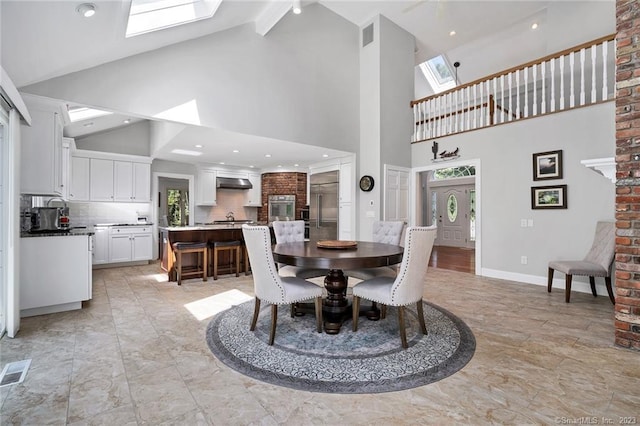 26 Ruscoe Rd, Wilton, CT 06897 - dining room with high vaulted ceiling, a skylight, plenty of natural light, beam ceiling, and light marble finish flooring